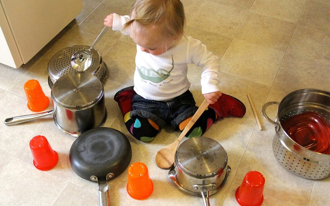 Child playing instruments made from the kitchen