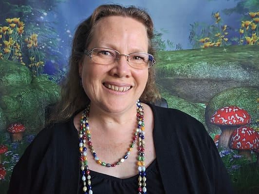Selfie of Michelle Whitehead in front of a fairyland backdrop